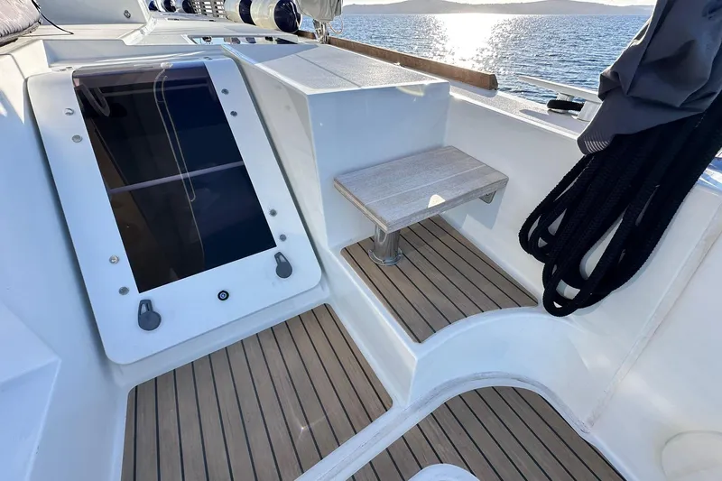  Yacht Photos Pics 2019 Lagoon 52 F yacht deck with wooden flooring and seating area.