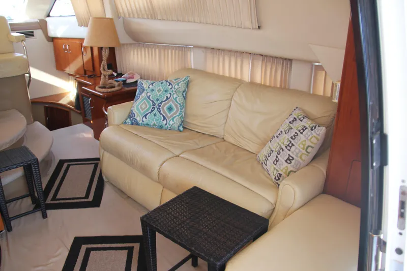  Yacht Photos Pics 2004 Carver 360 Sport Sedan interior with beige leather sofa and decorative pillows.