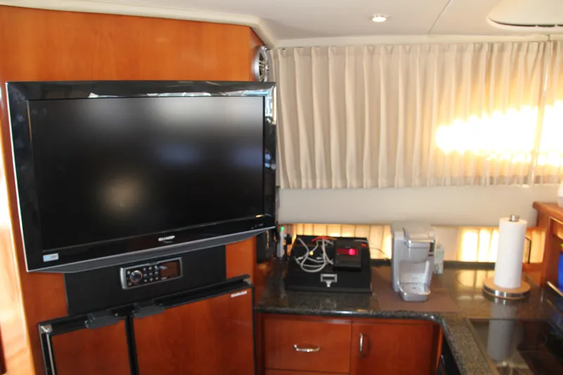  Yacht Photos Pics Interior of 2004 Carver 360 Sport Sedan with TV, appliances, and wooden cabinetry.