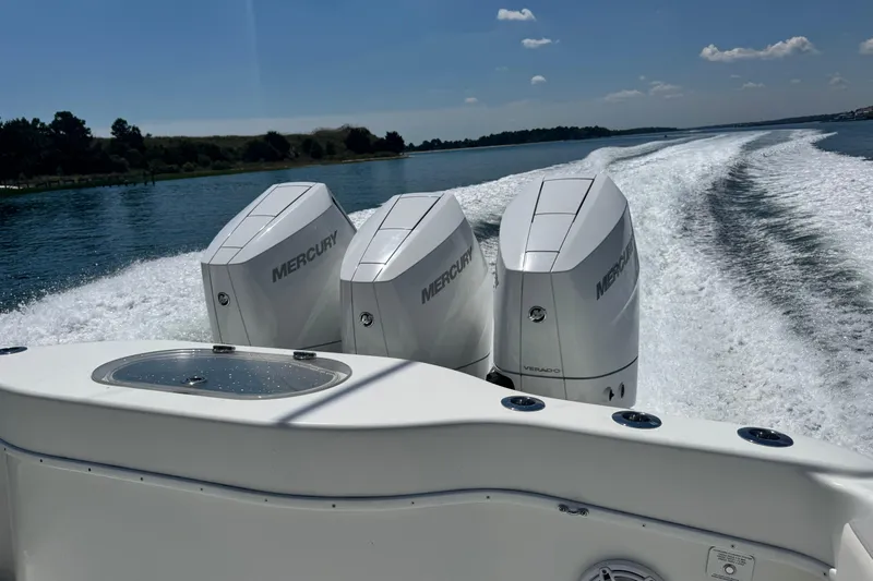  Yacht Photos Pics 2014 Yellowfin 42 Offshore boat with triple Mercury engines cruising on a sunny day.
