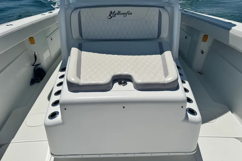  Yacht Photos Pics 2014 Yellowfin 42 Offshore boat seating area with cushioned bench and rod holders.