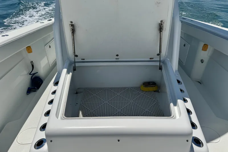  Yacht Photos Pics Open storage compartment on a 2014 Yellowfin 42 Offshore boat, with ocean in the background.