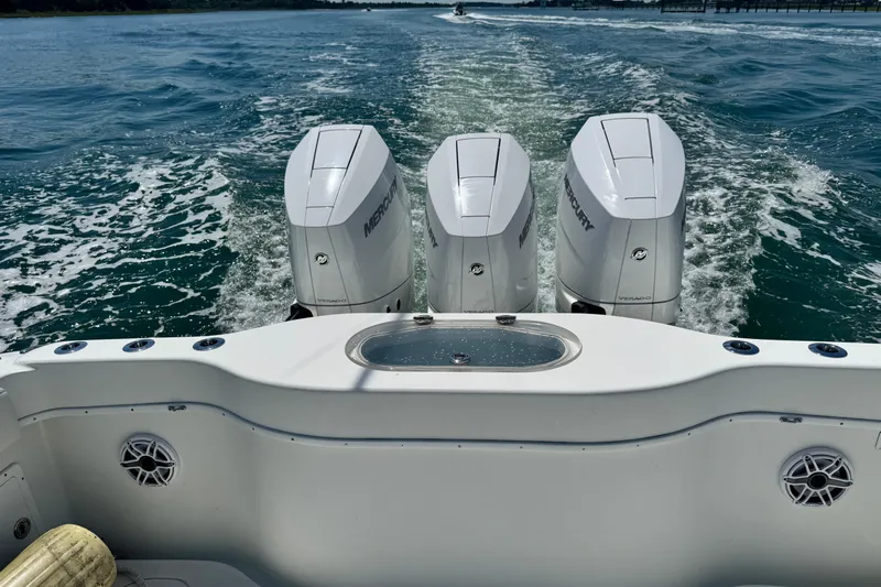  Yacht Photos Pics 2014 Yellowfin 42 Offshore boat with triple Mercury engines cruising on open water.