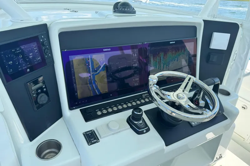 Yacht Photos Pics 2014 Yellowfin 42 Offshore helm with Simrad navigation displays and modern controls.