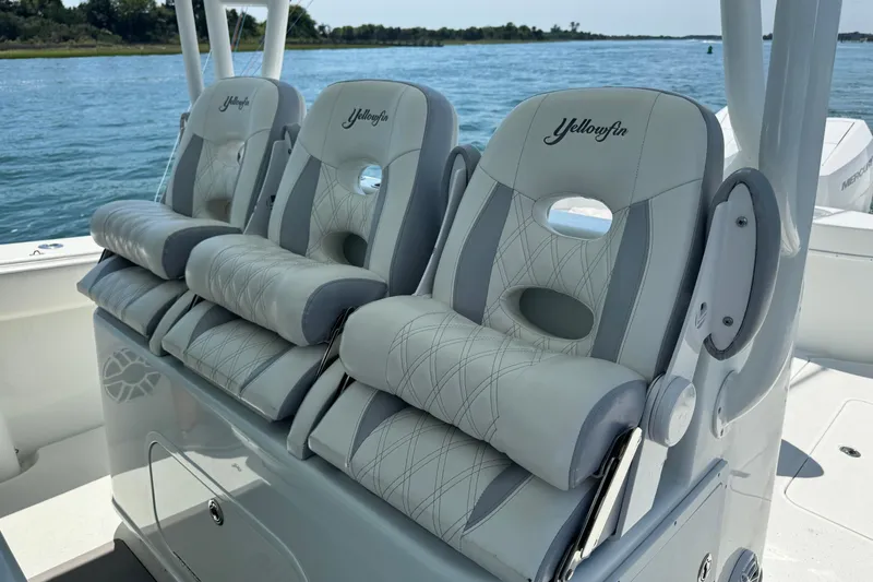  Yacht Photos Pics Luxury seating on 2014 Yellowfin 42 Offshore boat, featuring plush, embroidered cushions.