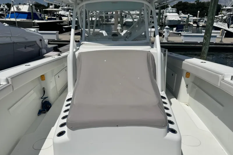  Yacht Photos Pics 2014 Yellowfin 42 Offshore boat at marina, featuring spacious deck and seating area.