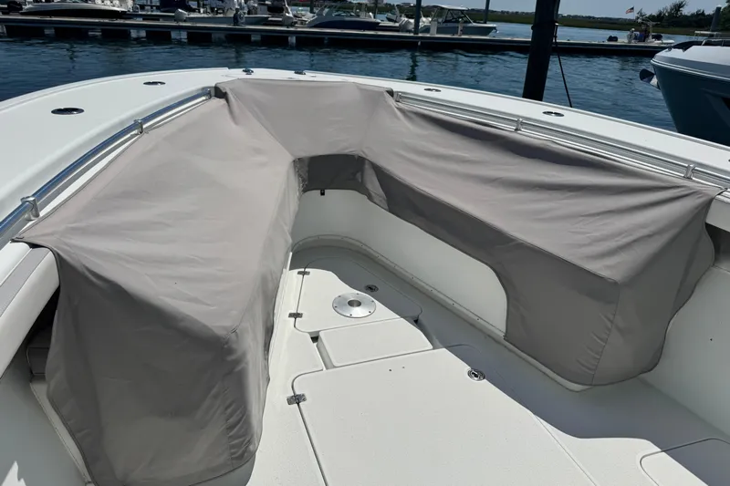  Yacht Photos Pics 2014 Yellowfin 42 Offshore boat with covered seating area at a marina.