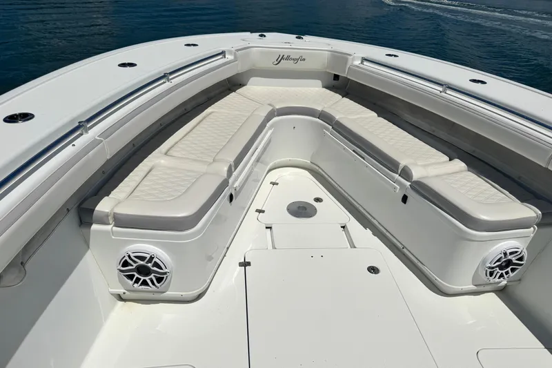  Yacht Photos Pics 2014 Yellowfin 42 Offshore boat with spacious seating and sleek design on calm water.