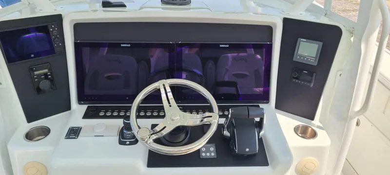  Yacht Photos Pics 2014 Yellowfin 42 boat dashboard with steering wheel and electronic controls.