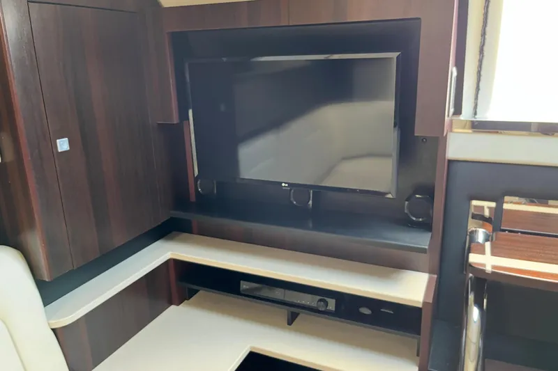  Yacht Photos Pics 2015 Monterey 415 Sport Yacht interior with TV and dark wood cabinetry.