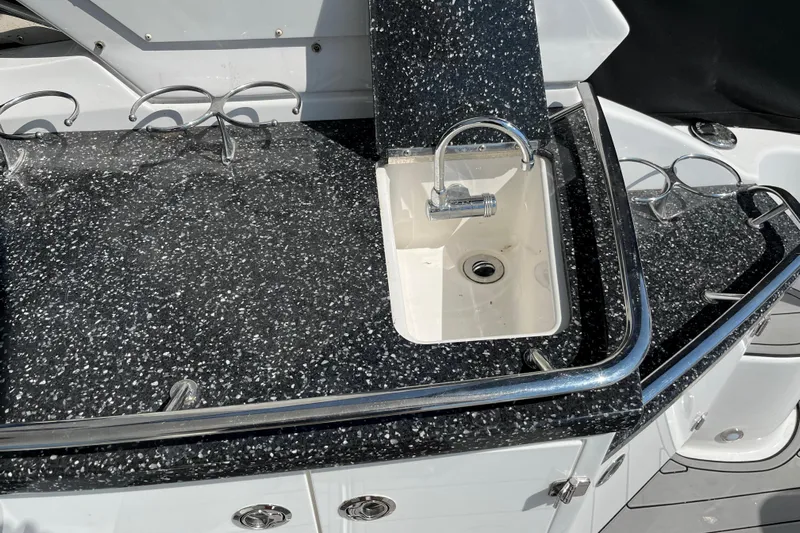  Yacht Photos Pics 2015 Monterey 415 Sport Yacht sink with speckled countertop and chrome fixtures.