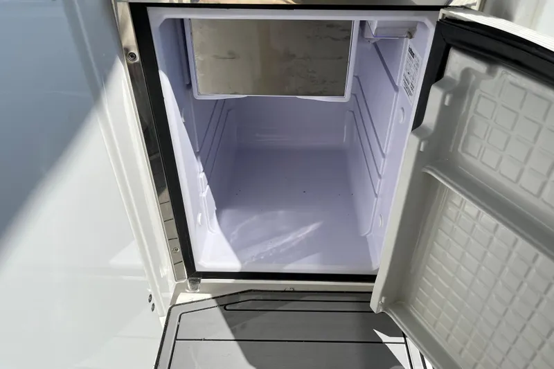  Yacht Photos Pics Open refrigerator on 2015 Monterey 415 Sport Yacht, showcasing interior storage space.