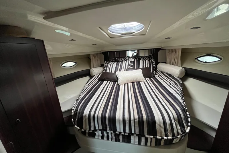  Yacht Photos Pics Luxurious cabin interior of 2015 Monterey 415 Sport Yacht with striped bedding.
