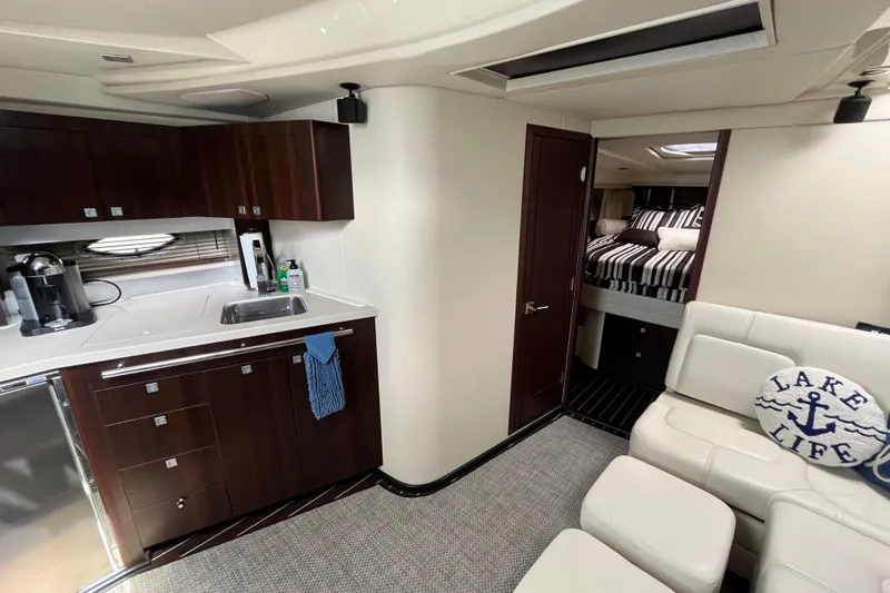  Yacht Photos Pics Luxurious interior of 2015 Monterey 415 Sport Yacht with kitchen and cozy bedroom.