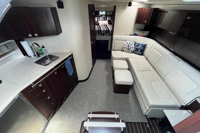  Yacht Photos Pics Luxurious interior of 2015 Monterey 415 Sport Yacht with modern kitchen and cozy seating.
