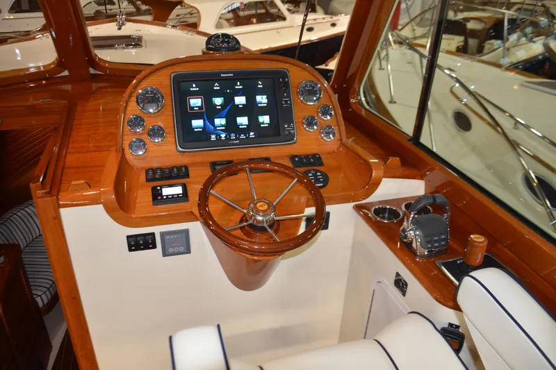 Standish Yacht Photos Pics Helm of 2017 Hinckley Picnic Boat 37 MKIII with wooden finish and modern controls.