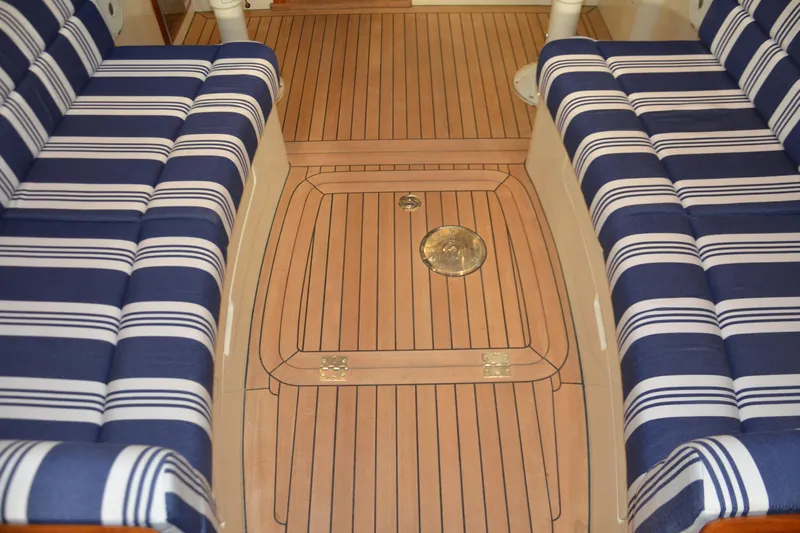 Standish Yacht Photos Pics 2017 Hinckley Picnic Boat 37 MKIII interior with striped seating and teak flooring.