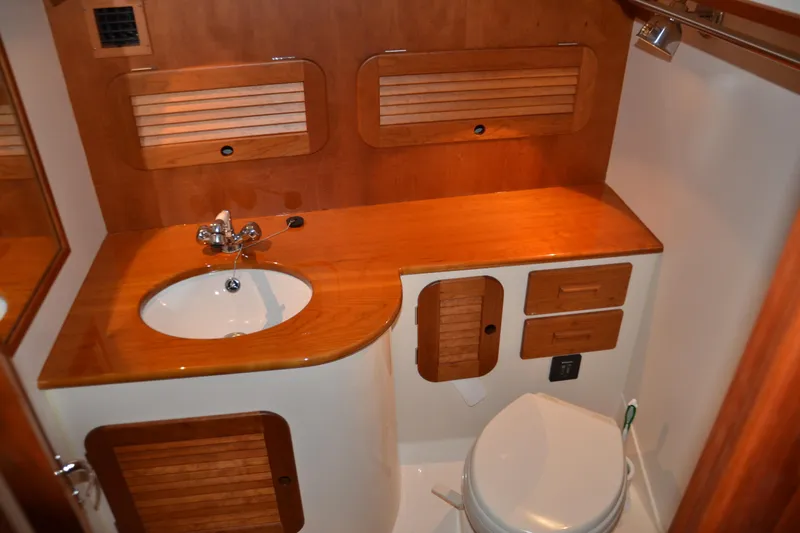 Standish Yacht Photos Pics 2017 Hinckley Picnic Boat 37 MKIII bathroom with wooden cabinetry and modern fixtures.