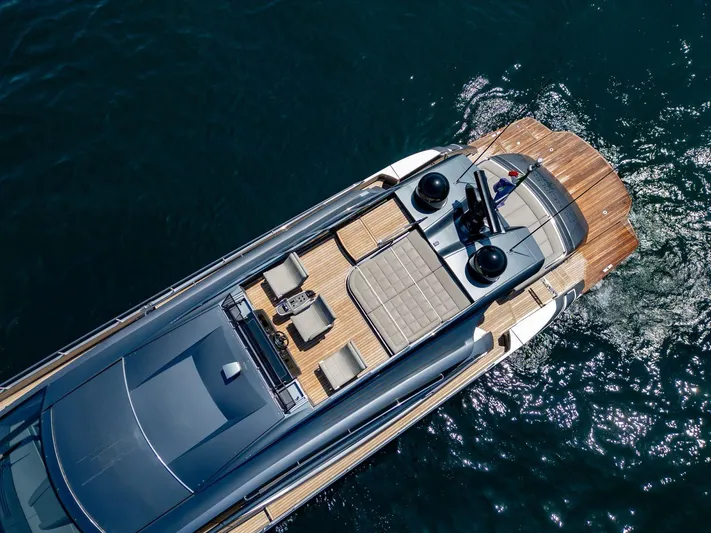  Yacht Photos Pics Aerial view of 2019 Pershing 82 yacht on water, showcasing sleek design and luxurious deck.