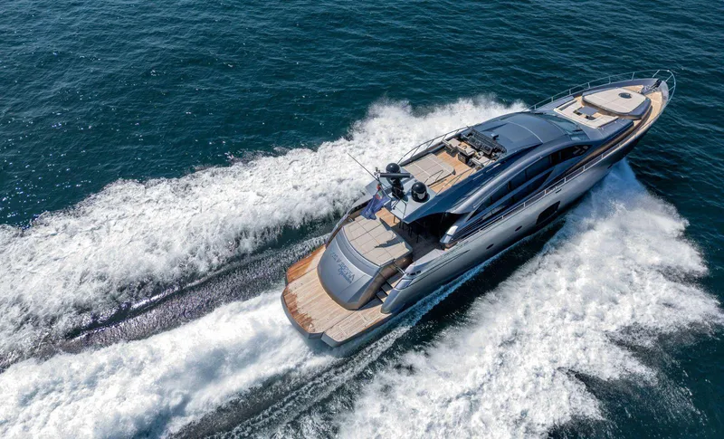  Yacht Photos Pics Luxurious 2019 Pershing 82 yacht cruising swiftly on open sea waters.