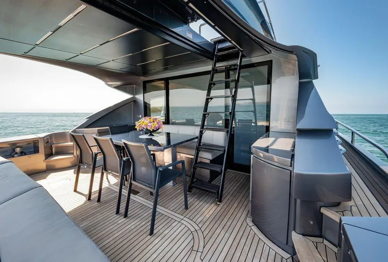  Yacht Photos Pics Luxurious 2019 Pershing 82 yacht deck with dining area, ocean view, and modern design.