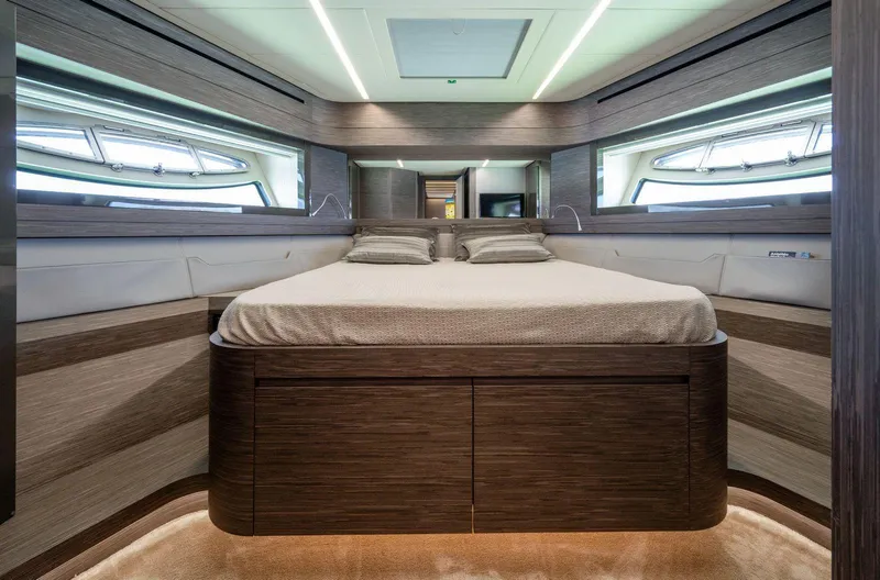  Yacht Photos Pics Luxurious bedroom interior of 2019 Pershing 82 yacht with modern design and elegant wood finishes.