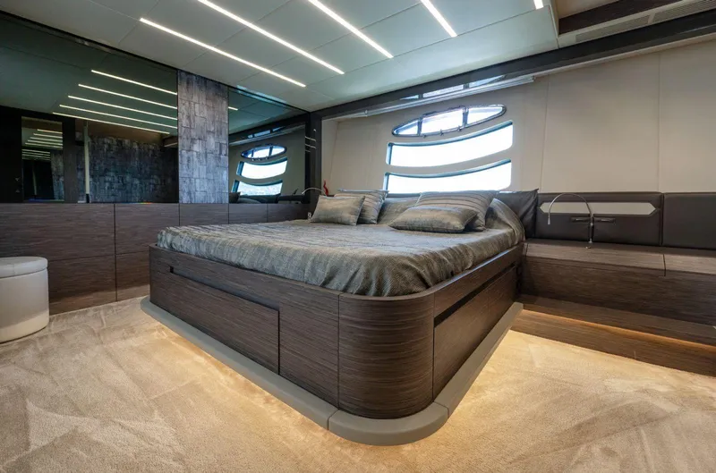  Yacht Photos Pics Luxurious bedroom interior of 2019 Pershing 82 yacht with modern design and ambient lighting.