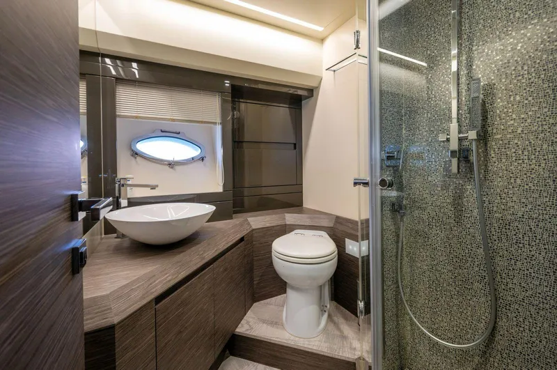  Yacht Photos Pics Luxurious bathroom in 2019 Pershing 82 yacht with modern fixtures and elegant design.