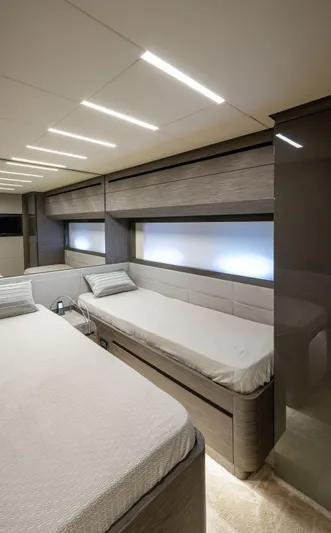  Yacht Photos Pics Luxurious bedroom interior of 2019 Pershing 82 yacht with modern design and ambient lighting.