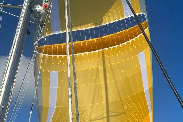 Endeavour Yacht Photos Pics Yellow sail of 2020 Fountaine Pajot Saona 47 against clear blue sky.