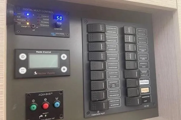 Endeavour Yacht Photos Pics Control panel of a 2020 Fountaine Pajot Saona 47 yacht with digital displays and switches.