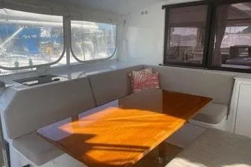 Endeavour Yacht Photos Pics 2020 Fountaine Pajot Saona 47 interior with dining area and large windows.