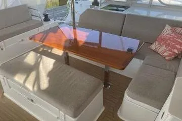 Endeavour Yacht Photos Pics 2020 Fountaine Pajot Saona 47 yacht interior with elegant seating and wooden table.