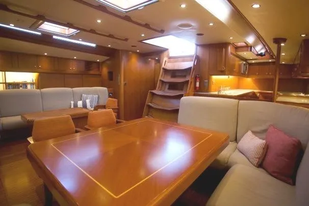 Josefina Yacht Photos Pics Luxurious interior of 1989 Nautor Swan 86 yacht with elegant wood furnishings and cozy seating.