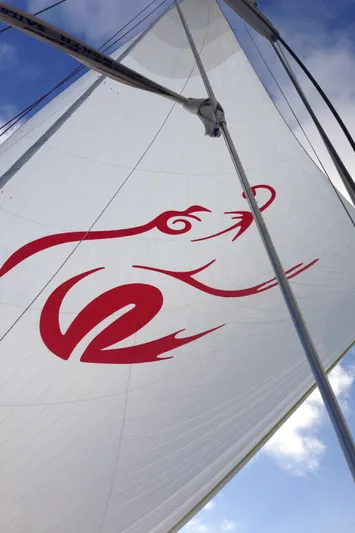 Josefina Yacht Photos Pics Sail of 1989 Nautor Swan 86 yacht with red logo against blue sky.