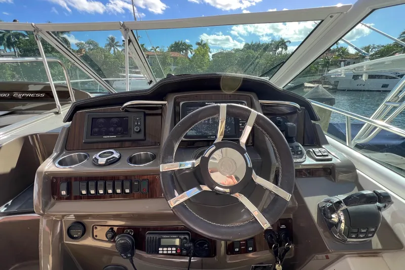 Life Of Leisure II Yacht Photos Pics Cockpit view of 2013 Cruisers Yachts 380 Express with steering wheel and control panel.