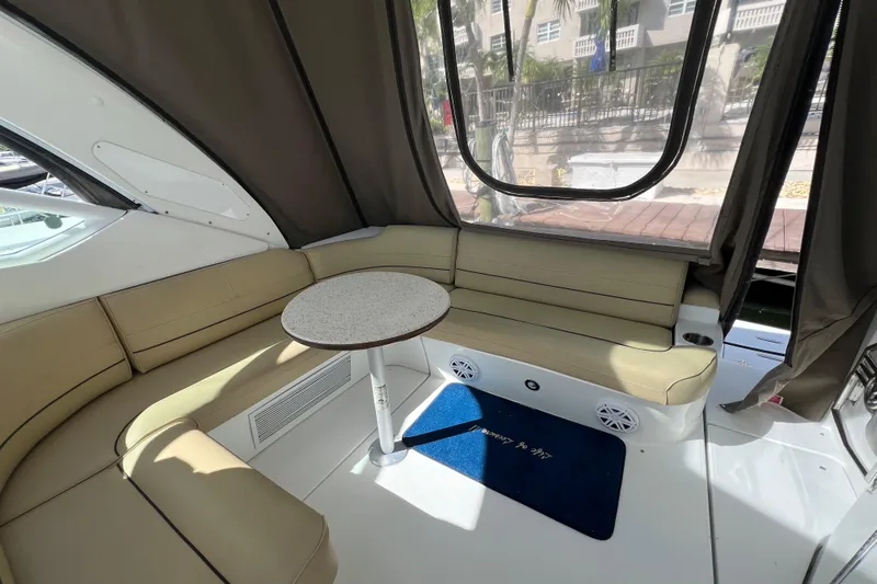 Life Of Leisure II Yacht Photos Pics Interior of 2013 Cruisers Yachts 380 Express with beige seating and round table.