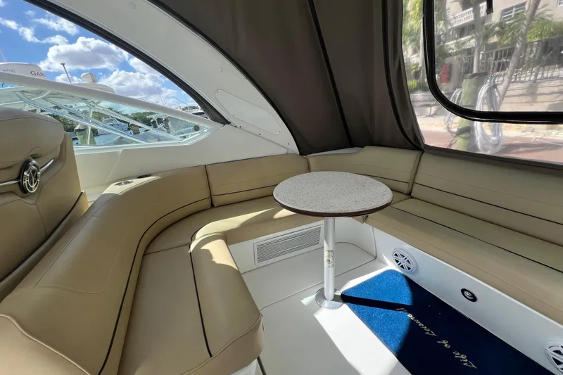 Life Of Leisure II Yacht Photos Pics Interior of 2013 Cruisers Yachts 380 Express with beige seating and round table.