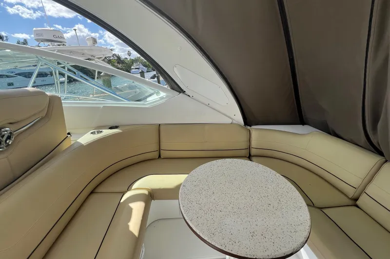 Life Of Leisure II Yacht Photos Pics Luxurious interior of 2013 Cruisers Yachts 380 Express with beige seating and round table.