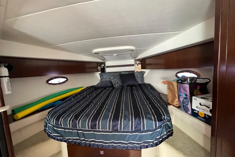 Life Of Leisure II Yacht Photos Pics 2013 Cruisers Yachts 380 Express cabin with bed, storage, and portholes.