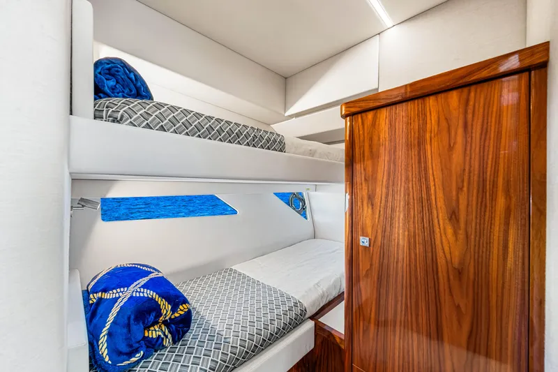  Yacht Photos Pics 2022 Riviera 505 SUV interior with wooden accents and bunk beds.