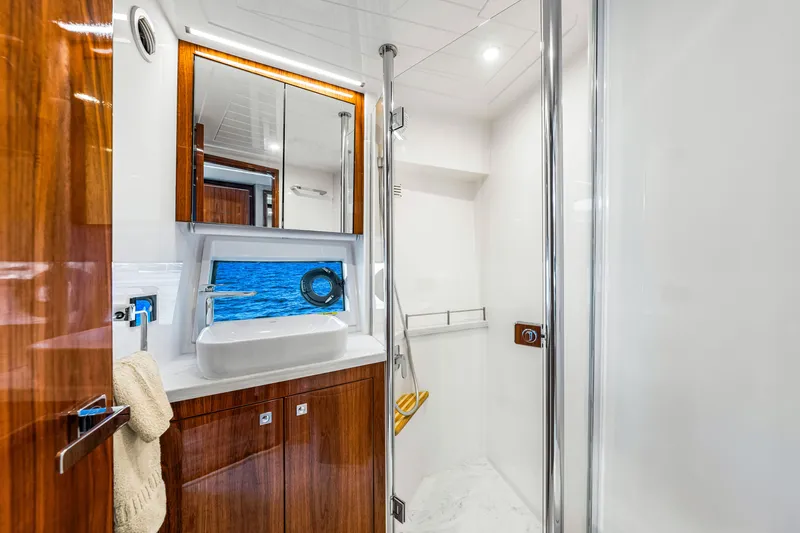  Yacht Photos Pics Luxurious bathroom interior of 2022 Riviera 505 SUV yacht with ocean view.