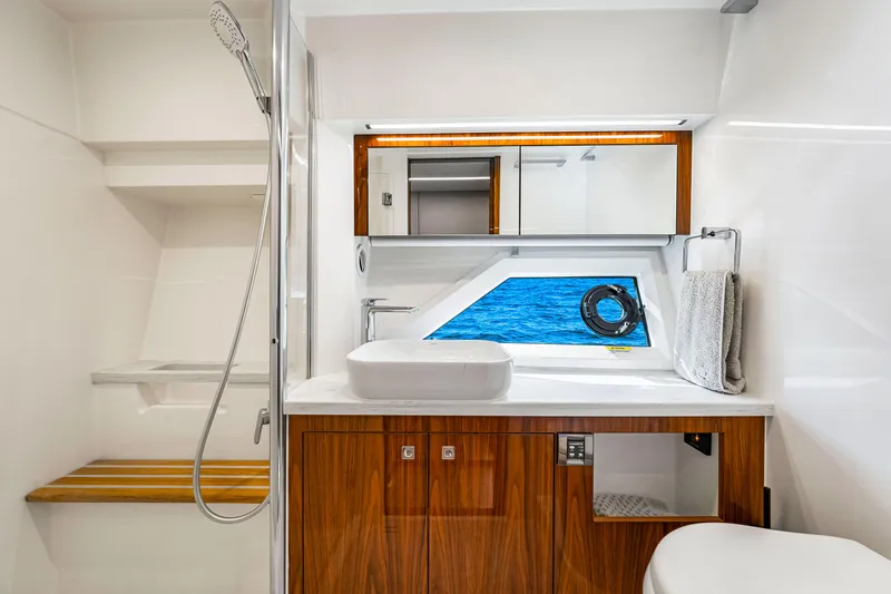  Yacht Photos Pics Luxurious bathroom in 2022 Riviera 505 SUV yacht with ocean view window.