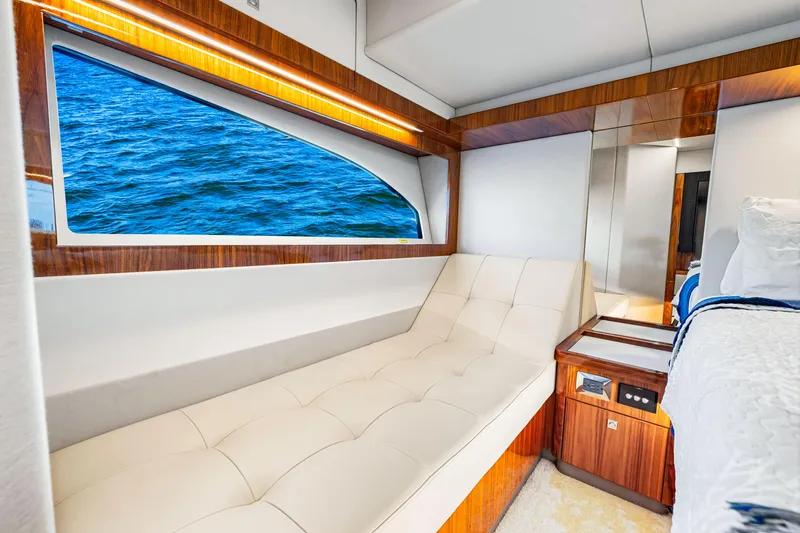  Yacht Photos Pics Luxurious interior of 2022 Riviera 505 SUV yacht with ocean view window.