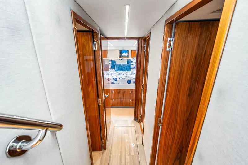  Yacht Photos Pics 2022 Riviera 505 SUV interior hallway with wooden doors and modern design.
