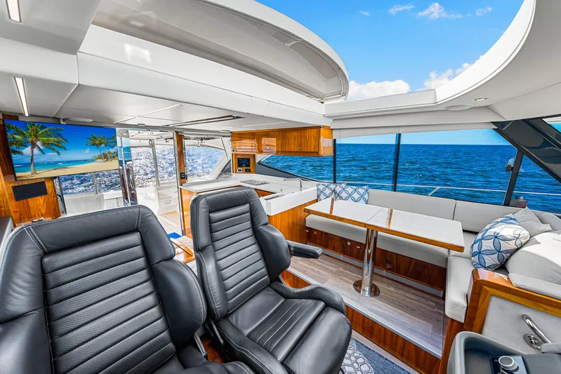  Yacht Photos Pics Luxurious 2022 Riviera 505 SUV yacht interior with ocean view, featuring leather seating and modern amenities.