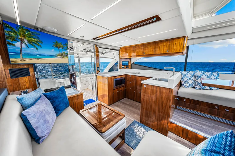  Yacht Photos Pics Luxurious interior of 2022 Riviera 505 SUV yacht with ocean view and elegant wood finishes.
