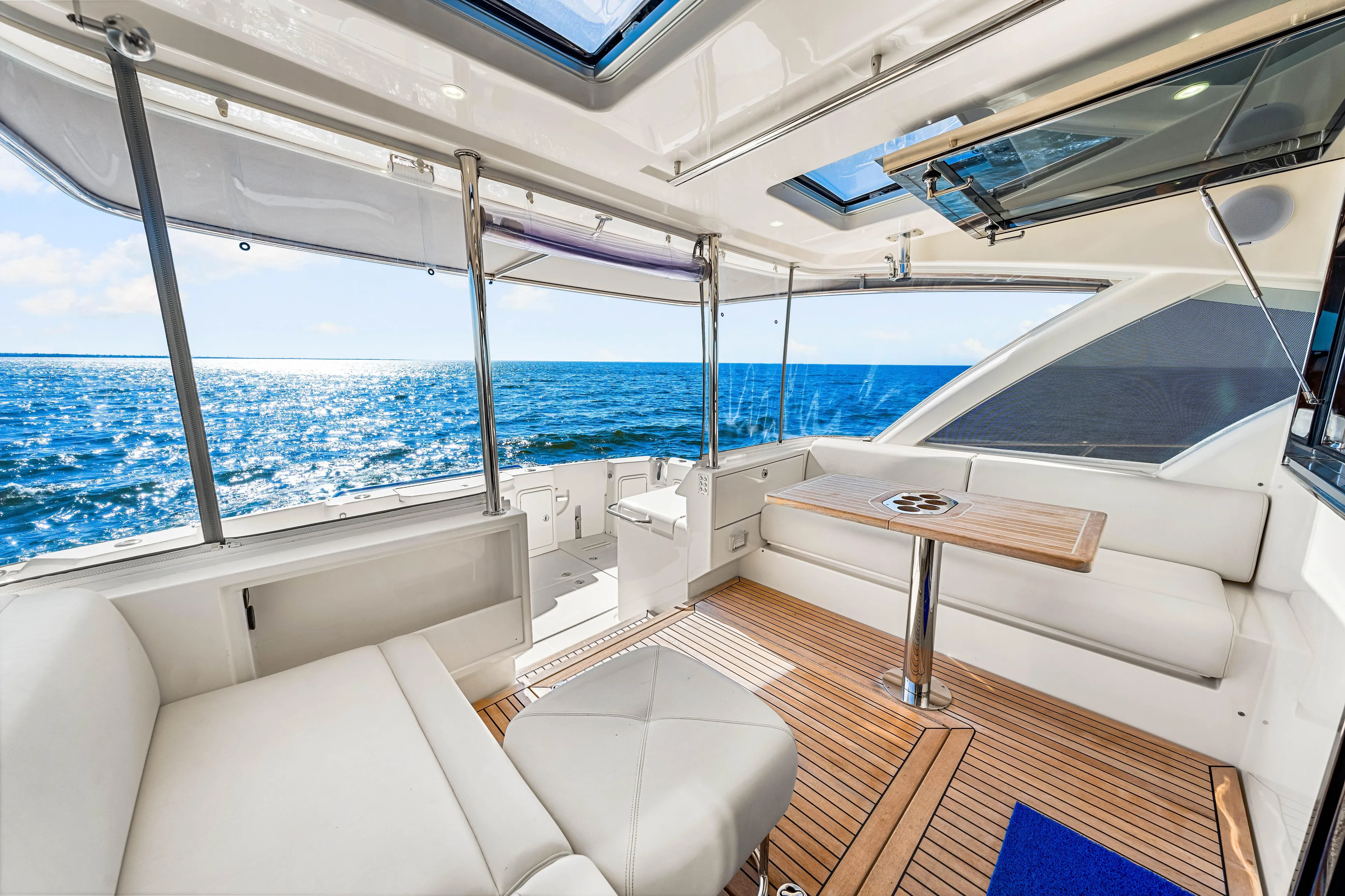  Yacht Photos Pics Luxurious 2022 Riviera 505 SUV yacht interior with ocean view and elegant seating area.