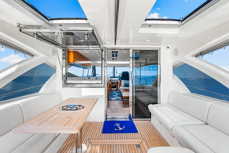  Yacht Photos Pics Luxurious interior of 2022 Riviera 505 SUV yacht with elegant seating and ocean view.