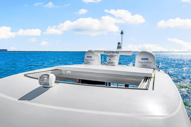  Yacht Photos Pics 2022 Riviera 505 SUV yacht with Garmin equipment, cruising on a sunny ocean.